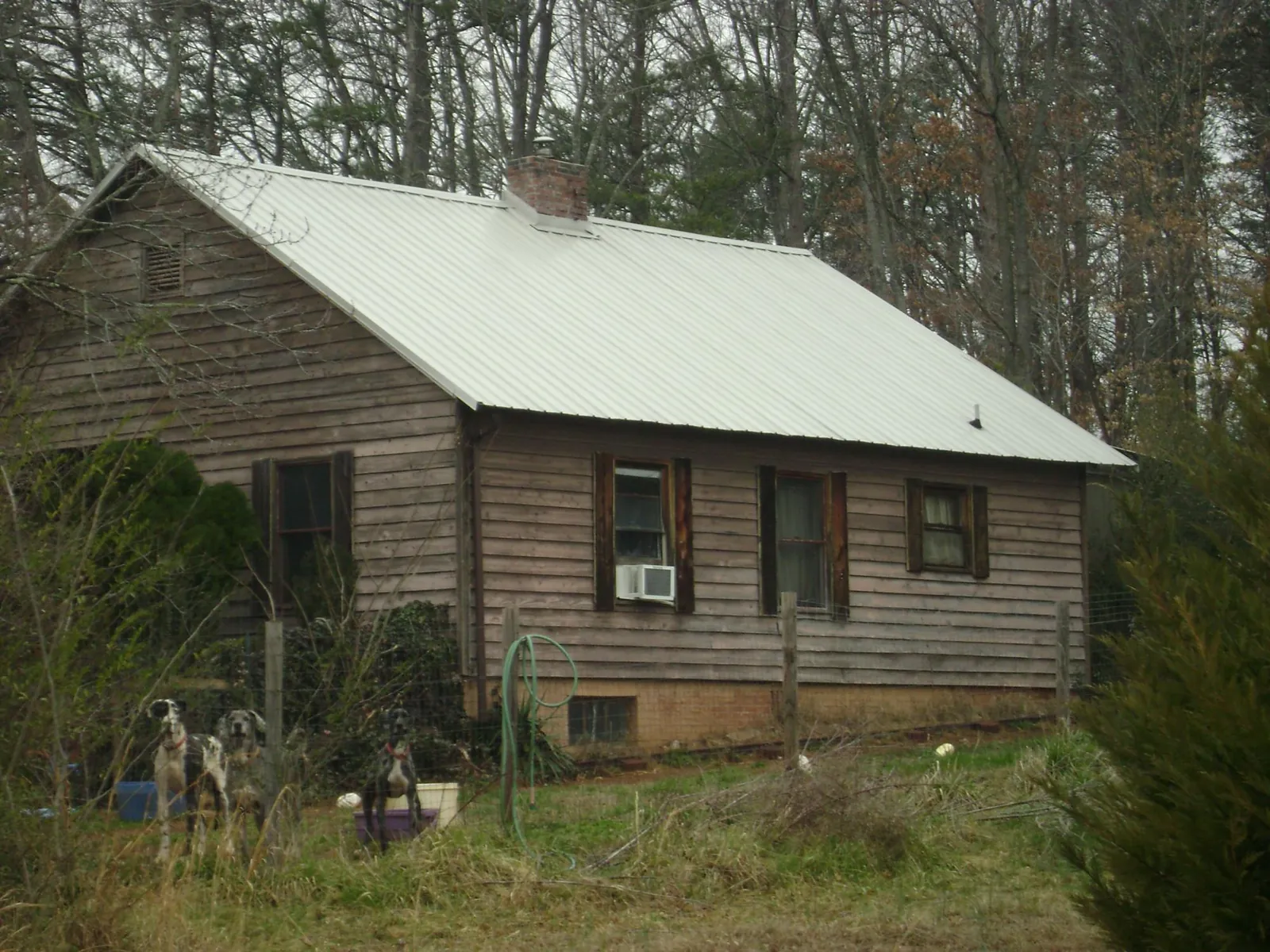 White metal roof on an old wood sided farmhouse, from a Metal Roof Installation job in Kennedale